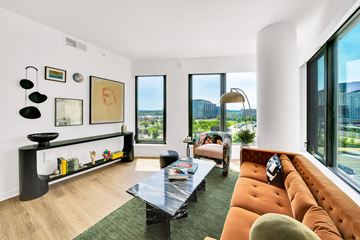Washington apartment for rent - A living room with a black coffee table and orange couch.