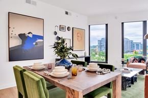 Washington apartment for rent - A dining room with a wooden table set for a meal.