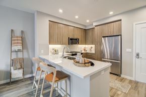 Morgan Hill apartment for rent - a kitchen with a large island and a stainless steel refrigerator