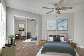 La Jolla apartment for rent - A bedroom with a bed, a desk, a chair, a ceiling fan, and two framed pictures on the wall.