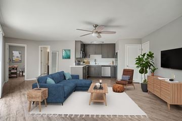 La Jolla apartment for rent - A living room with a blue couch and a wooden coffee table.