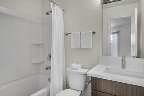 La Jolla apartment for rent - A white bathroom with a toilet, sink, and bathtub.
