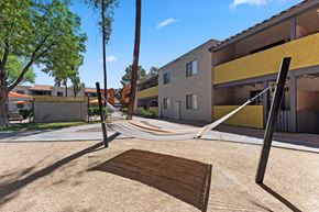 Tempe apartment for rent - a hammock is hung on a pole in a courtyard at the whispering winds apartments in pear