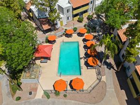 Tempe apartment for rent - Areal view of the pool deck with orange umbrellas at the best apartments in Tempe, AZ.
