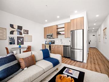 Seattle apartment for rent - A modern living room with a grey couch and a coffee table.