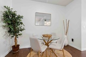 Glendale apartment for rent - A dining room with a glass table and white chairs.