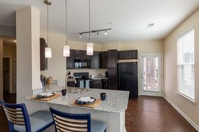Aurora apartment for rent - a kitchen with black appliances and a granite counter top