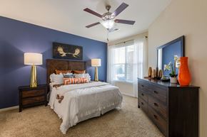 Aurora apartment for rent - a bedroom with a bed and a ceiling fan
