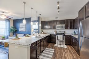 Parker apartment for rent - A modern kitchen with dark brown cabinets and stainless steel appliances.