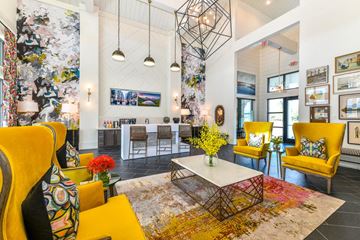 N Charleston apartment for rent - a living room with yellow chairs and a table