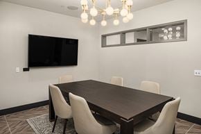 Seattle apartment for rent - a dining room with a table and chairs and a tv on the wall