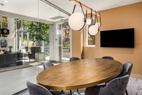 Seattle apartment for rent - a dining room with a table and chairs and a tv