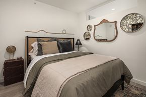 Seattle apartment for rent - a bedroom with a bed and mirrors on the wall