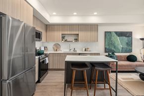 Seattle apartment for rent - a  kitchen with stainless steel appliances and a counter with three stools