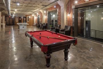 Philadelphia apartment for rent - A pool table in a room with brick walls.