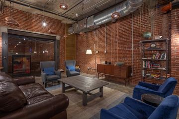 Philadelphia apartment for rent - A living room with a brown leather couch and blue chairs.