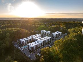 Nashville apartment for rent - A sunny day at a resort with a swimming pool and a view of the surrounding greenery.