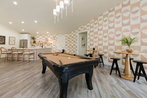 Mesa apartment for rent - a billiards table in a clubhouse with a bar and tables
