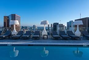 San Diego apartment for rent - a pool with lounge chairs and lamps on top of a building at Stanza Little Italy, California, 92101