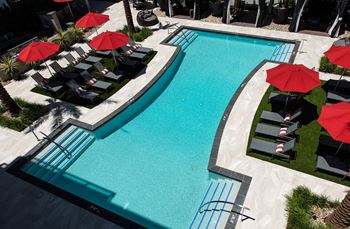 Resort-style pool with outdoor dining and pool-side cabanas