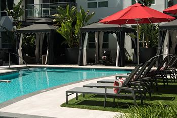Resort-style pool with outdoor dining and pool-side cabanas