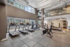 Seattle apartment for rent - A gym with treadmills, elliptical machines, and other exercise equipment.