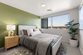 Seattle apartment for rent - A bedroom with a large bed and a view of the outside.