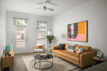 Phoenix apartment for rent - a living room with a leather couch and a coffee table