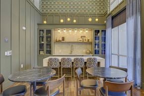 Dallas apartment for rent - A dining room with a table surrounded by chairs.