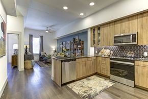 Austin apartment for rent - A kitchen with wooden cabinets and a tiled backsplash.