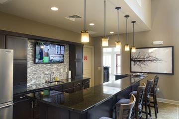 Wichita apartment for rent - A modern kitchen with dark cabinets and a stainless steel refrigerator.