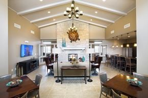 Wichita apartment for rent - A large dining room with a fireplace and a television.