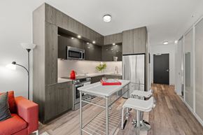 San Francisco apartment for rent - A modern kitchen with a red sofa and a stainless steel table.