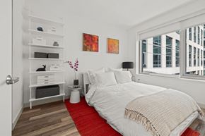 San Francisco apartment for rent - A bedroom with a large bed and a red rug.