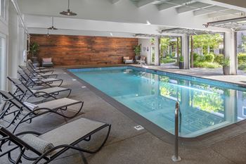 Indoor heated pool with roll up windows and ajacent sun deck