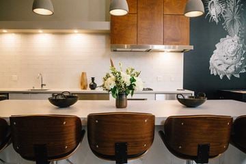 Berkeley apartment for rent - A kitchen with a white counter top and wooden chairs.
