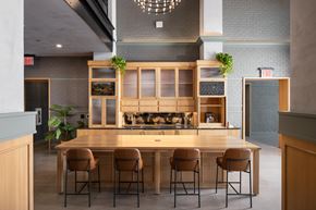 Nashville apartment for rent - A modern kitchen with a long wooden table and chairs.
