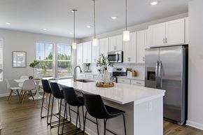 Waldorf apartment for rent - A kitchen with a white countertop and black barstools.