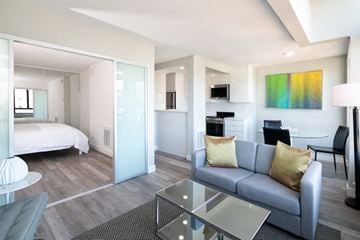 San Francisco apartment for rent - A modern living room with a grey couch and a glass table.