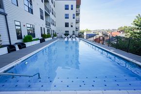 Covington apartment for rent - A swimming pool in a residential area with buildings in the background.