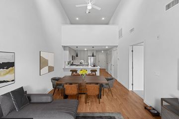 Fairfield apartment for rent - A modern living room with a grey couch and a wooden dining table.