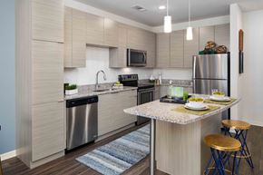 Tampa apartment for rent - A modern kitchen with a dining table set for two.