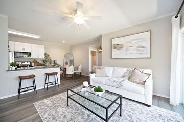 Murrieta apartment for rent - A modern living room with a white couch and a glass coffee table.