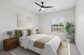 Chamblee apartment for rent - A bedroom with a large bed and a ceiling fan.