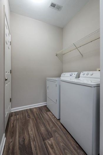 Laundry room with white machines