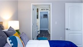 Atlanta apartment for rent - a bedroom with a bed and a hallway with a bathroom