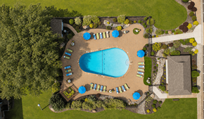 Carrboro apartment for rent - An aerial view of a swimming pool surrounded by trees and lawn.