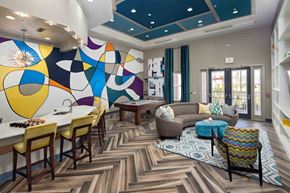 Tampa apartment for rent - A modern dining room with a colorful mural on the wall.