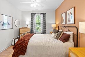 Concord apartment for rent - A bedroom with a large bed and a ceiling fan.