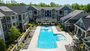 Concord apartment for rent - A large swimming pool surrounded by apartment buildings.